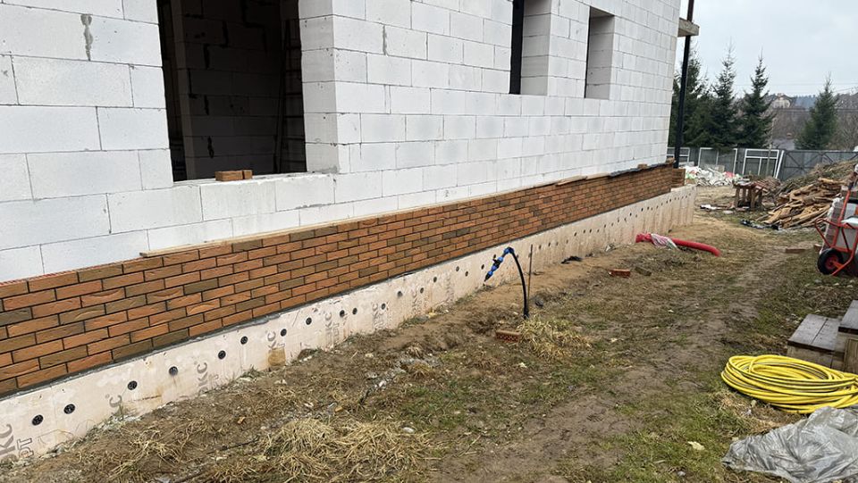 Процесс облицовки двухэтажного дома из газобетона