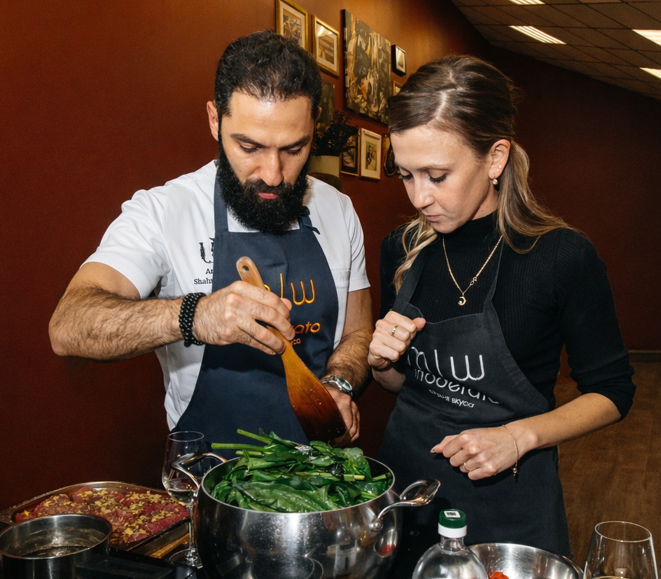 Шеф повар обучает людей готовить в кулинарной студии